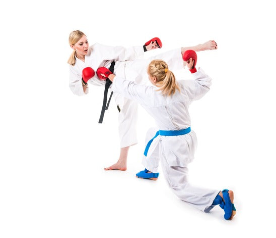 Two martial artists sparring with each other with one kicking