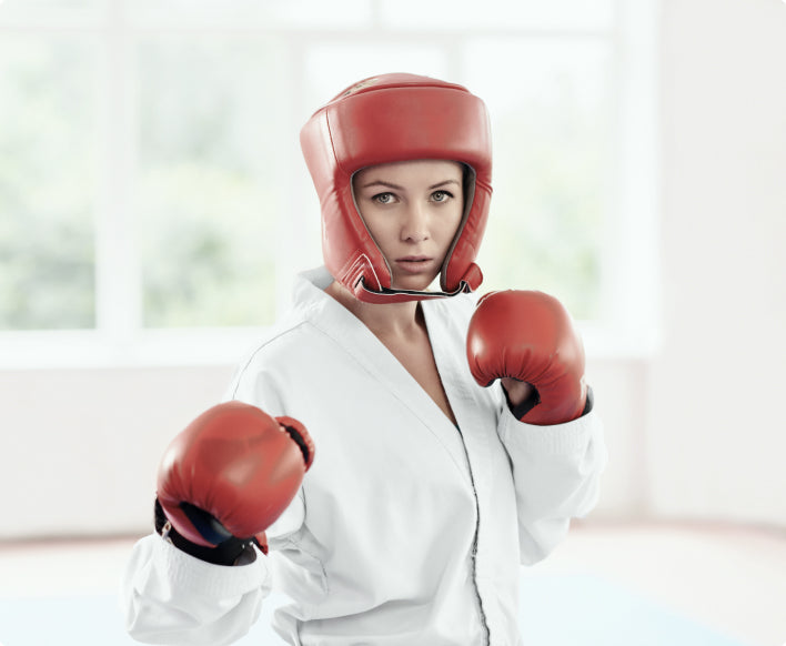Woman in sparring headgear and chop