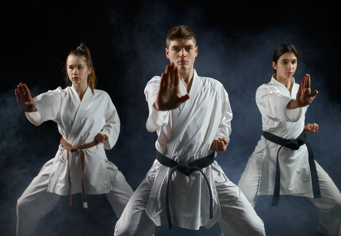 three martial artists performing a palm strike